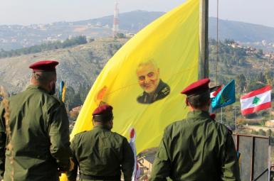 Lebanese Hezbollah forces with a banner showing Iranian general Qasem Soleimani. FILE