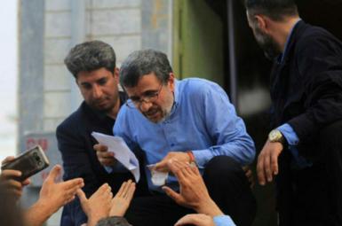 Iran's former president Mahmoud Ahmadinejad reading petitions during one his trips to regions. Undated