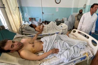 Wounded Afghan men receive treatment at a hospital after explosions outside airport in Kabul, August 27, 2021.