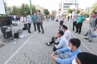 People in a Tehran street watching the second presidential debate. June 8, 2021