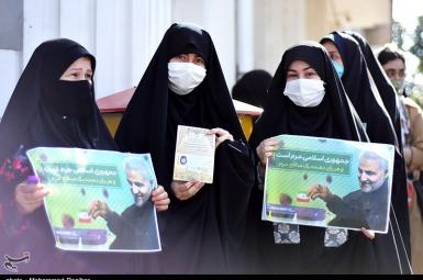 A group of women voters in segregated que holding posters of Qasem Soleimani killed by the US. June 18, 2021