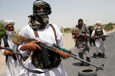 Former Mujahideen hold weapons to support Afghan forces in their fight against Taliban, on the outskirts of Herat province, Afghanistan July 10, 2021.