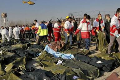 Rescue workers comb the debris after the downing of airliner. January 8, 2020