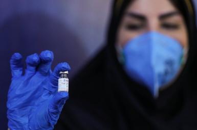 An Iranian official showing what is claimed to be a homegrown vaccine. December 29, 2020