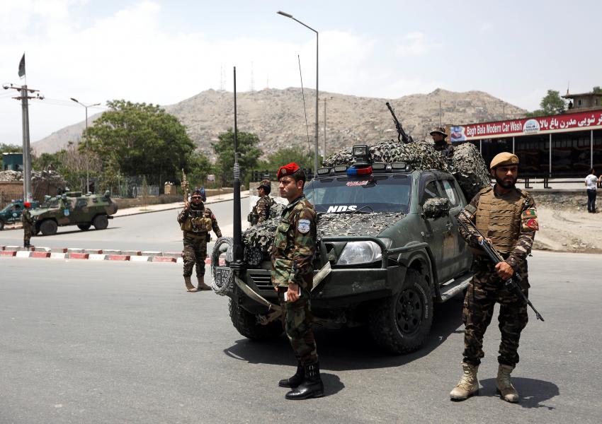 Afghan security forces on guard after a blast in Kabul as a ceasefire begins with the Taliban