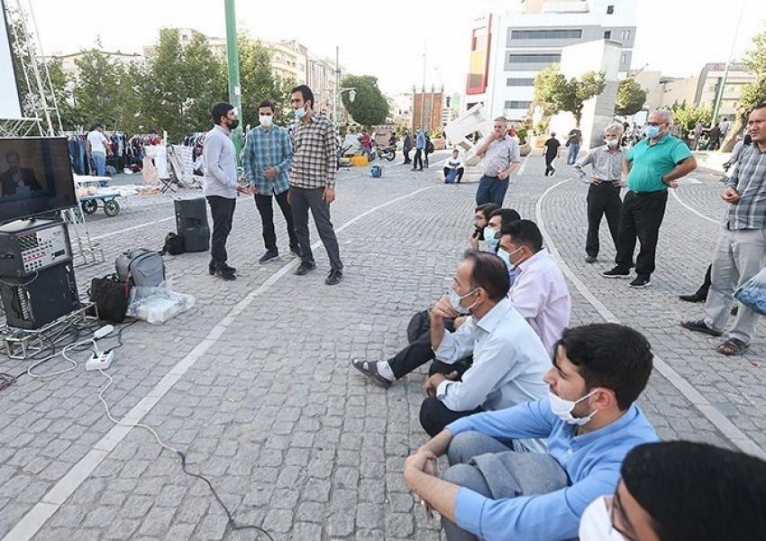 People in a Tehran street watching the second presidential debate. June 8, 2021