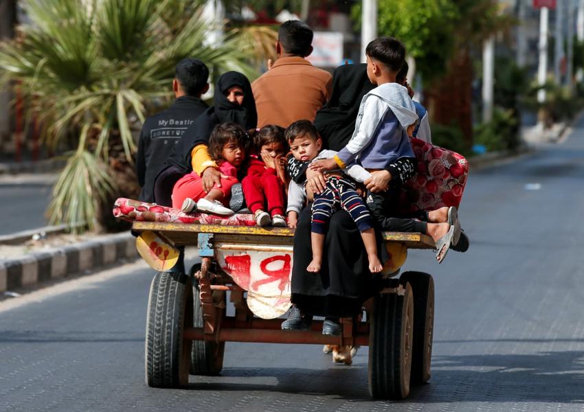 Palestinians riding on a donkey-drawn cart flee their homes during Israeli air and artillery strikes, in Gaza City May 14, 2021.